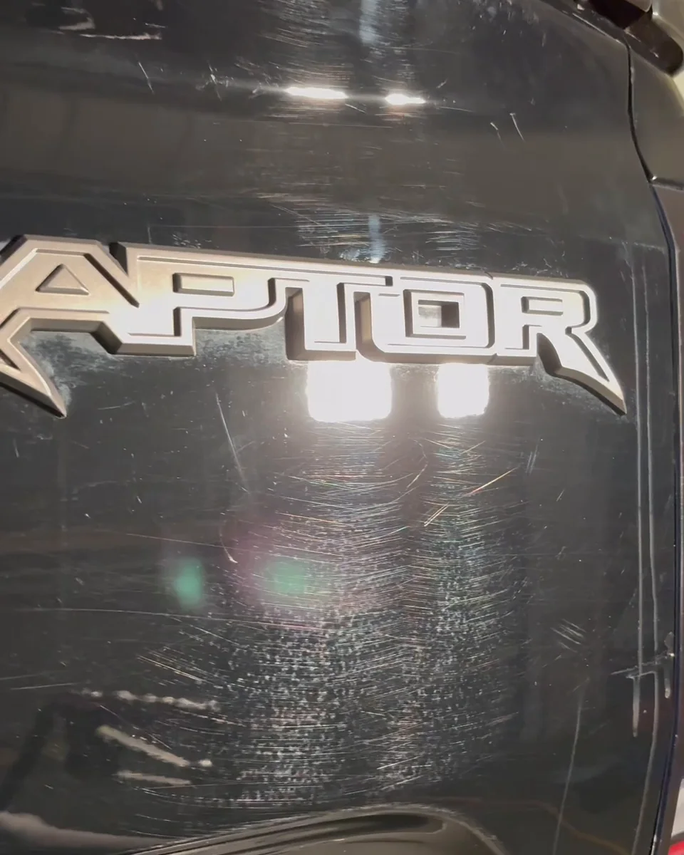 Tailgate before paint correction: swirl marks and wash scratches under the inspection light